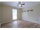 Bright bedroom with hardwood floors, a window, and minimalist decor at 8829 Gelligum Dr, Charlotte, NC 28277