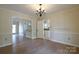 Dining room features hardwood floors, chandelier and view into kitchen, perfect for entertaining at 8829 Gelligum Dr, Charlotte, NC 28277