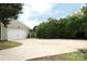 The expansive driveway leads to a two-car garage, complemented by lush greenery and landscaping for a welcoming approach at 8829 Gelligum Dr, Charlotte, NC 28277