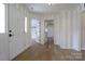 Spacious entryway with hardwood floors, paneled doors, and neutral paint palette at 8829 Gelligum Dr, Charlotte, NC 28277