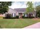 Charming single-story home with manicured lawn, lush landscaping, and a welcoming front porch at 8829 Gelligum Dr, Charlotte, NC 28277