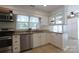 Well-lit kitchen features stainless steel appliances, granite countertops, and white cabinets at 8829 Gelligum Dr, Charlotte, NC 28277