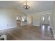 Spacious living room with beautiful hardwood floors, chandelier and an open floor plan concept at 8829 Gelligum Dr, Charlotte, NC 28277