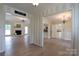 Open-concept living room featuring hardwood floors, fireplace, and views into the kitchen and other rooms at 8829 Gelligum Dr, Charlotte, NC 28277