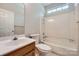 Bathroom featuring a single sink vanity, a toilet, and a combined bathtub and shower with white tile at 8909 Elkins Park Dr, Matthews, NC 28105