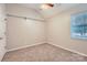 Bright bedroom with new carpet, a ceiling fan, closet with rod and shelf, and large windows at 8909 Elkins Park Dr, Matthews, NC 28105