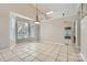 Open dining room with tile floors, ample natural light, and modern light fixture at 8909 Elkins Park Dr, Matthews, NC 28105