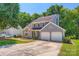 Charming gray two-story home featuring an attached two-car garage and mature landscaping at 8909 Elkins Park Dr, Matthews, NC 28105