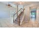 Bright foyer featuring tile floors, stairs with wood railings, and an open floor plan at 8909 Elkins Park Dr, Matthews, NC 28105