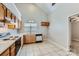 Functional kitchen features tile floors, bright natural light, wood cabinetry, and laminate countertops at 8909 Elkins Park Dr, Matthews, NC 28105