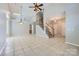 Spacious living area with high ceilings, tile flooring, and a ceiling fan at 8909 Elkins Park Dr, Matthews, NC 28105