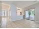 Open concept living room with tile flooring, neutral paint, and sliding doors leading to the outdoors at 8909 Elkins Park Dr, Matthews, NC 28105