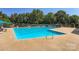 Large outdoor community pool with plenty of seating and clear blue water surrounded by shade trees at 8909 Elkins Park Dr, Matthews, NC 28105