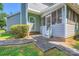 Gray home featuring a covered, screened porch, steps, and a landscaped walkway at 8909 Elkins Park Dr, Matthews, NC 28105