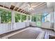 Enclosed sunroom featuring a ceiling fan, wood flooring, and large windows overlooking the backyard at 8909 Elkins Park Dr, Matthews, NC 28105