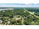Aerial view of a home nestled among lush trees near a lake and golf course at 1036 Foreman Ct, Denver, NC 28037