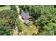 Aerial view of a home showcasing a spacious backyard with a deck, fire pit, garden, and a detached garage at 1036 Foreman Ct, Denver, NC 28037