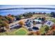 Aerial view of the Cowan's Ford Golf and Swim Club surrounded by lush trees with a view of the lake at 1036 Foreman Ct, Denver, NC 28037