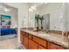 A bathroom featuring a double vanity with granite countertop and natural wood cabinets at 1036 Foreman Ct, Denver, NC 28037