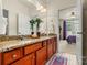 A bathroom featuring a double vanity with granite countertop and natural wood cabinets at 1036 Foreman Ct, Denver, NC 28037