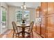 Cozy dining area with hardwood floors, a round wooden table, and natural light from the windows at 1036 Foreman Ct, Denver, NC 28037
