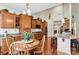 Bright dining area featuring hardwood floors, a wooden table, and easy access to the kitchen at 1036 Foreman Ct, Denver, NC 28037