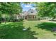Beautiful two-story home with a stone and siding exterior, lush green lawn, and mature trees at 1036 Foreman Ct, Denver, NC 28037