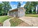 Detached two-car garage with white doors, side entry, and a paved driveway, offering ample parking space at 1036 Foreman Ct, Denver, NC 28037