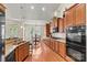 Well-equipped kitchen featuring granite countertops, stainless steel appliances, and wood cabinetry at 1036 Foreman Ct, Denver, NC 28037