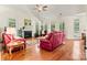 Bright living room featuring hardwood floors, a fireplace, and large windows with natural light at 1036 Foreman Ct, Denver, NC 28037