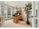 Bright home office with a large window, built-in shelving, and a wooden desk at 1036 Foreman Ct, Denver, NC 28037