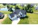 Aerial view of a modern home with a three-car garage, beautiful landscaping, and a lush green yard at 108 Augusta Ln, Shelby, NC 28150