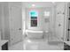 Bright bathroom featuring a standalone tub and a glass-enclosed shower, offering a modern and open design at 108 Augusta Ln, Shelby, NC 28150