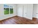 Bright, minimalist bedroom with hardwood floors, a large window and white trim at 108 Augusta Ln, Shelby, NC 28150