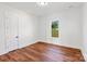 Bright bedroom with hardwood floors and a large window offers natural light and a view of the outdoors at 108 Augusta Ln, Shelby, NC 28150