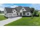 Charming modern farmhouse with a three-car garage, lush lawn and elegant black and white trim at 108 Augusta Ln, Shelby, NC 28150