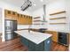 Well-equipped kitchen with stainless steel appliances, kitchen island, stylish cabinets and floating shelves at 108 Augusta Ln, Shelby, NC 28150