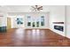 Expansive living area featuring hardwood floors, large windows, and a cozy fireplace, offering ample natural light at 108 Augusta Ln, Shelby, NC 28150