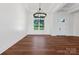 Bright, open living space with wood floors, a modern chandelier, and large windows offering a welcoming atmosphere at 108 Augusta Ln, Shelby, NC 28150