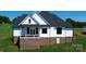 Rear view of home featuring a brick foundation, second story balcony, and black framed windows at 108 Augusta Ln, Shelby, NC 28150