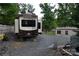 Back view of a Columbus RV parked on gravel lot at 114 Redwood Trl, Mount Gilead, NC 27306