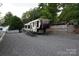 Columbus RV on gravel lot with access ramp, ready for adventure and relaxation at 114 Redwood Trl, Mount Gilead, NC 27306