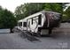 A large, modern Columbus RV with a ramp sits on a gravel lot at 114 Redwood Trl, Mount Gilead, NC 27306
