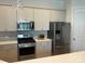 Kitchen featuring stainless steel appliances and a decorative hanging light fixture at 11608 Founders Park Ln, Pineville, NC 28134