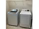 Laundry room with front load washer and dryer, with wire shelving at 11608 Founders Park Ln, Pineville, NC 28134