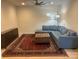Spacious living room with blue sectional, ornate rug, and accent cabinet at 11608 Founders Park Ln, Pineville, NC 28134