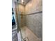 Modern bathroom shower with glass door, bench, and tile surround at 11608 Founders Park Ln, Pineville, NC 28134