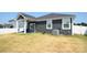New construction home featuring an open backyard and covered patio area with a ceiling fan at 12209 Riceland Way, Midland, NC 28107