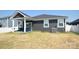 New construction home featuring an open backyard and covered patio area with a ceiling fan at 12209 Riceland Way, Midland, NC 28107