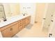 Bathroom features a long vanity with a bright white countertop, plus a neutral-toned tile floor at 12209 Riceland Way, Midland, NC 28107